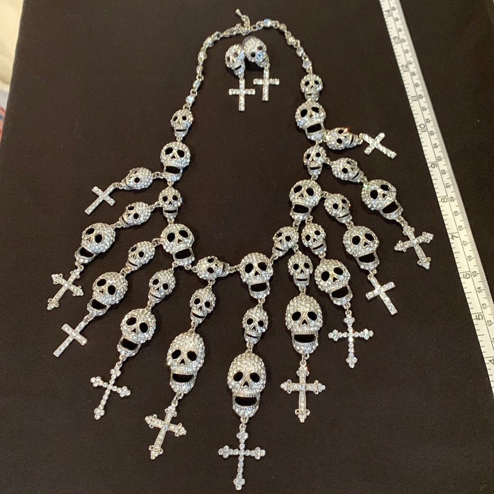 Silver, crystal skull, and cross necklace with matching earrings